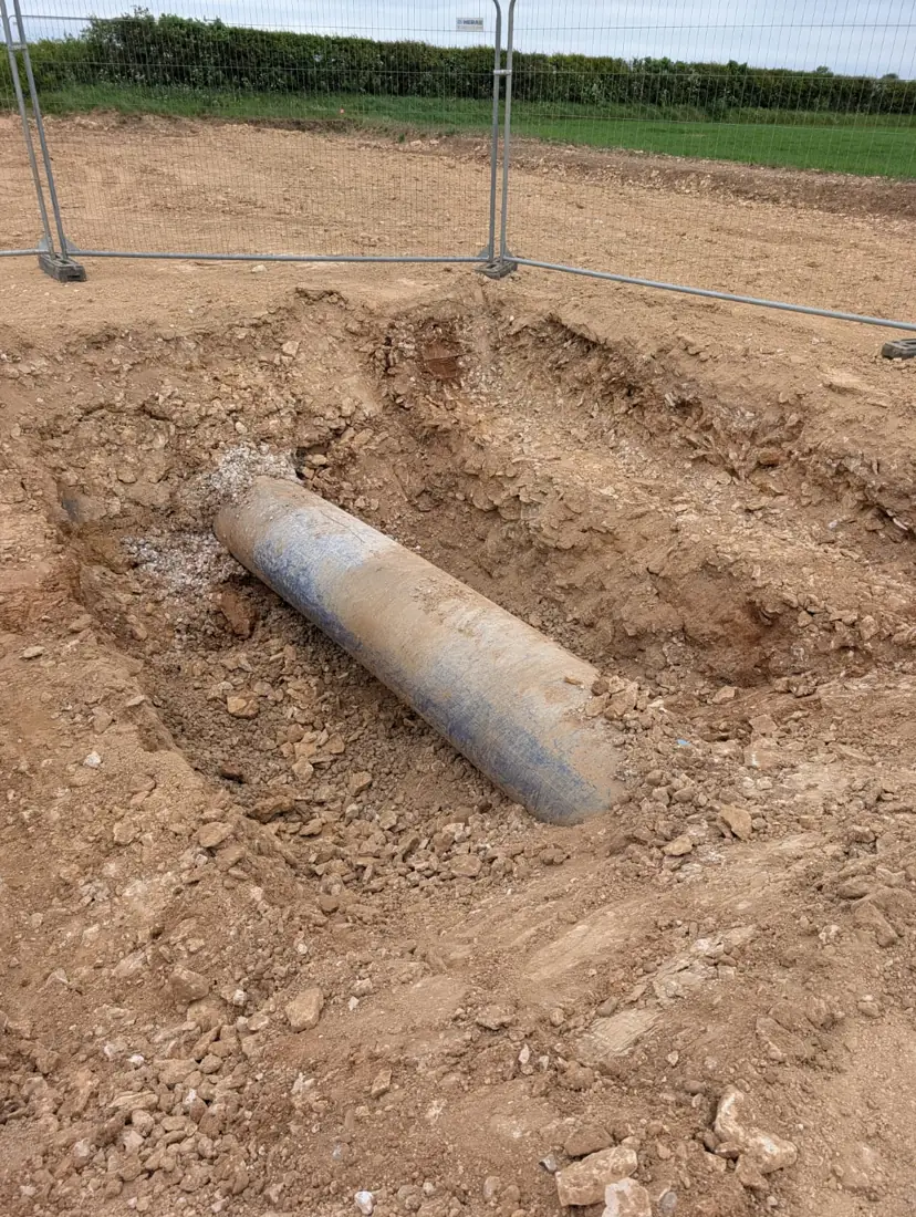 Large water main exposed in a pit
